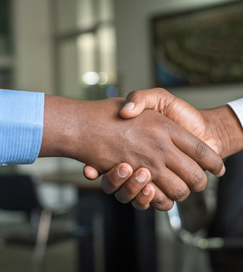 Business partners shaking hands after an agreement